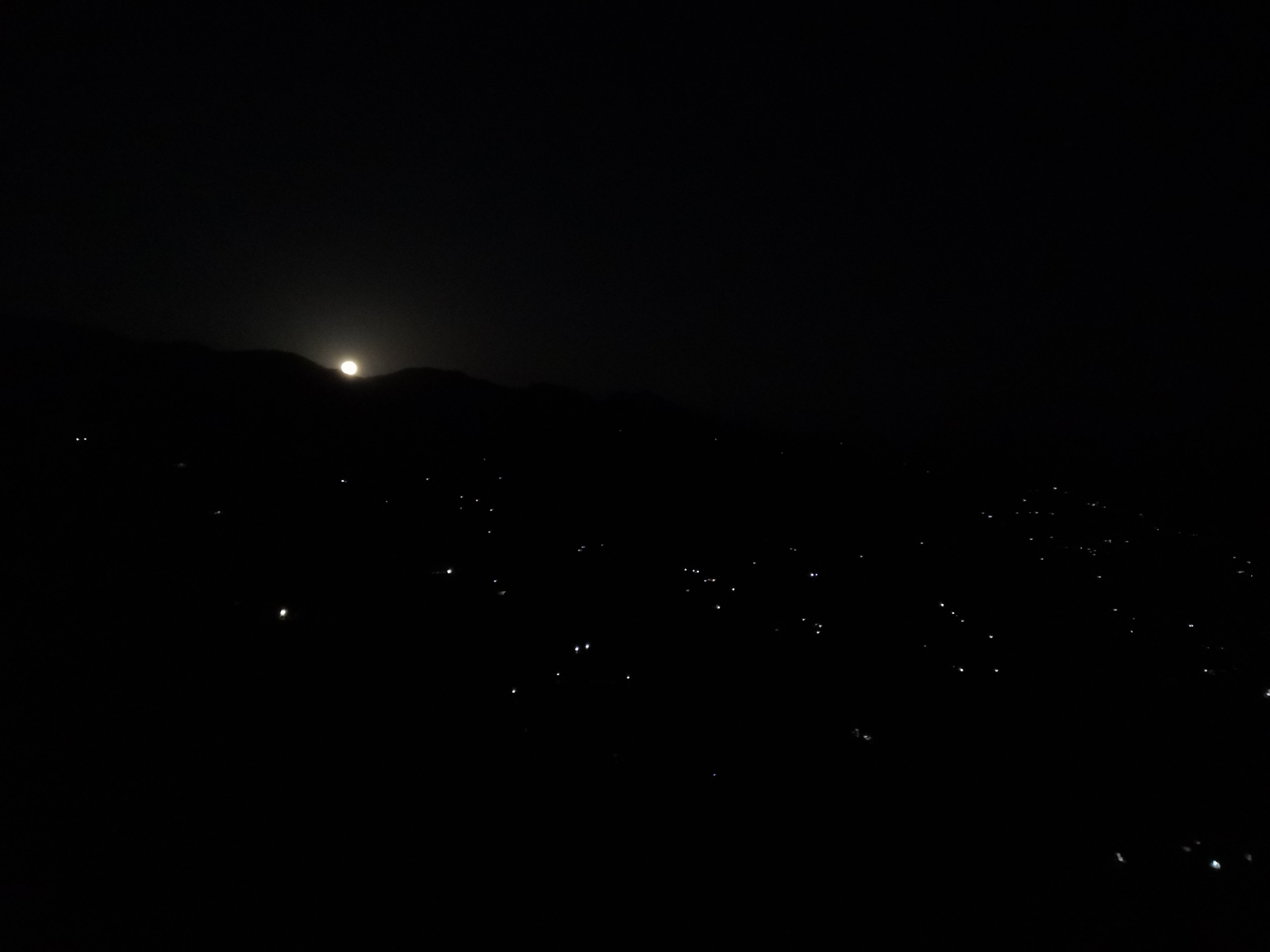 Moon rising behind the mountains